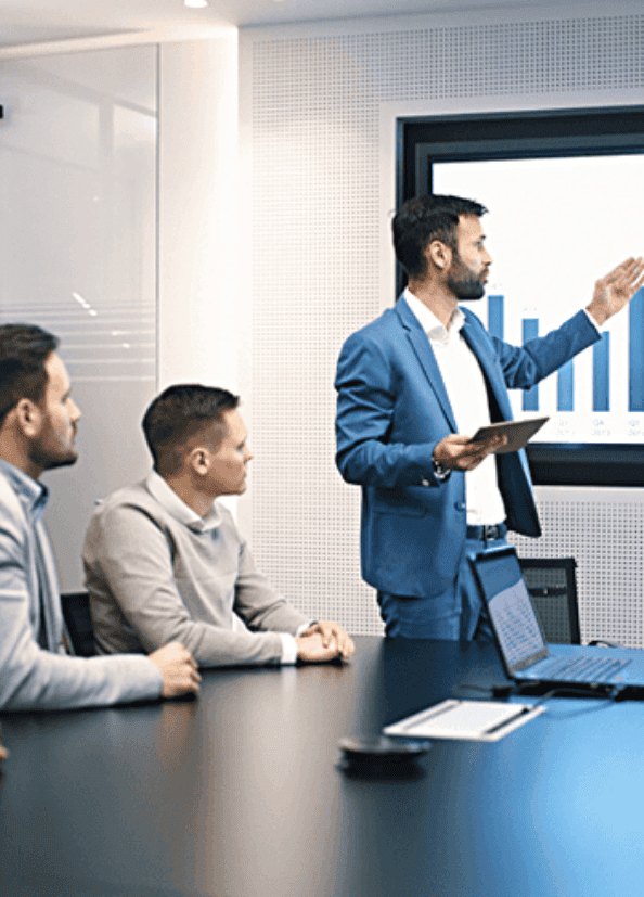 Business meeting with chart on display